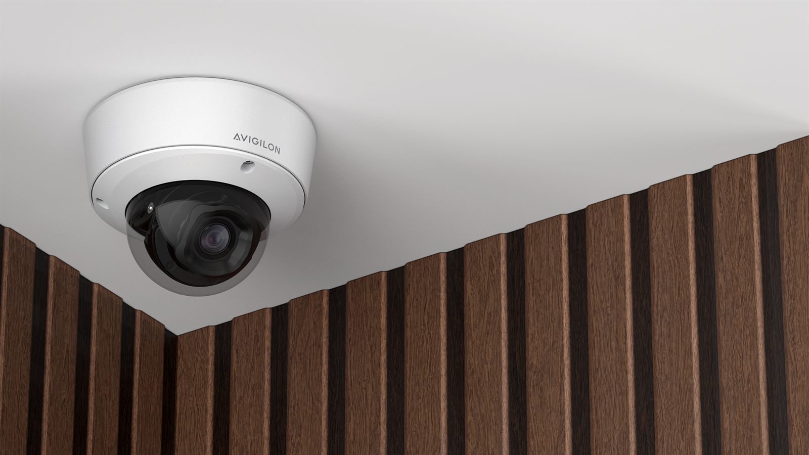 A dome camera mounted on the ceiling of a room with a wood slat wall.